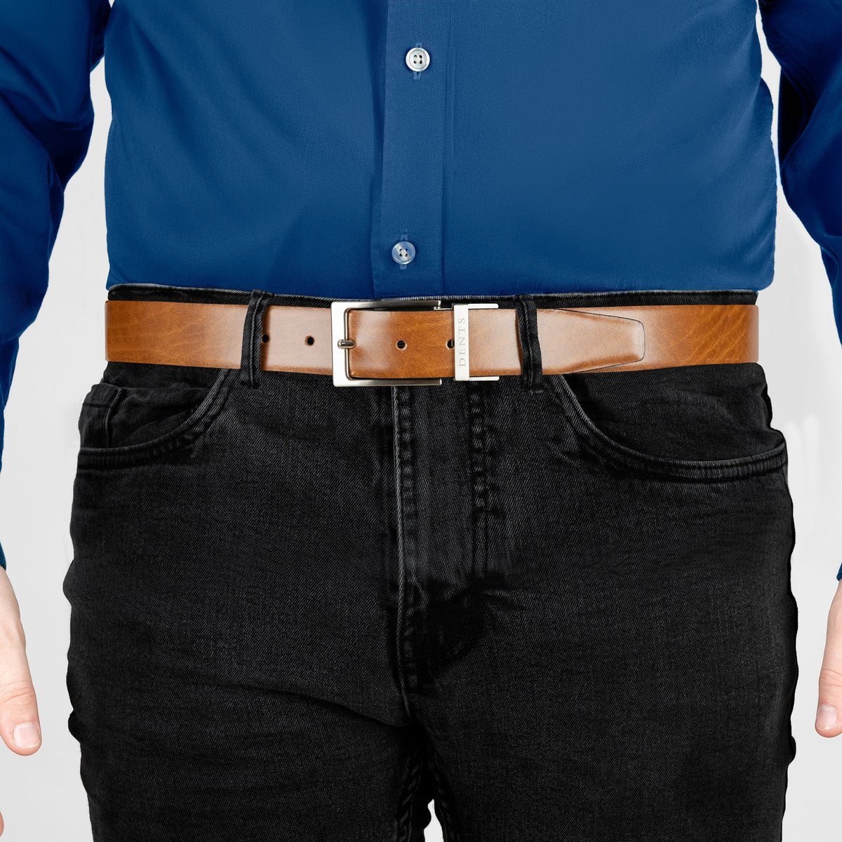 Man wearing heritage reversible full-grain leather belt with satin nickel buckle in black/tan, front.