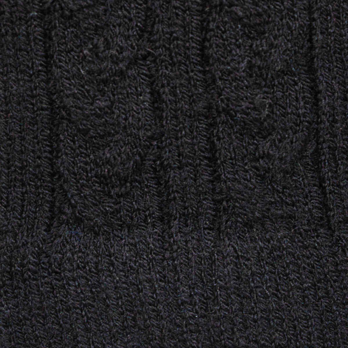 Women's cable knit gloves in black, fabric close up.