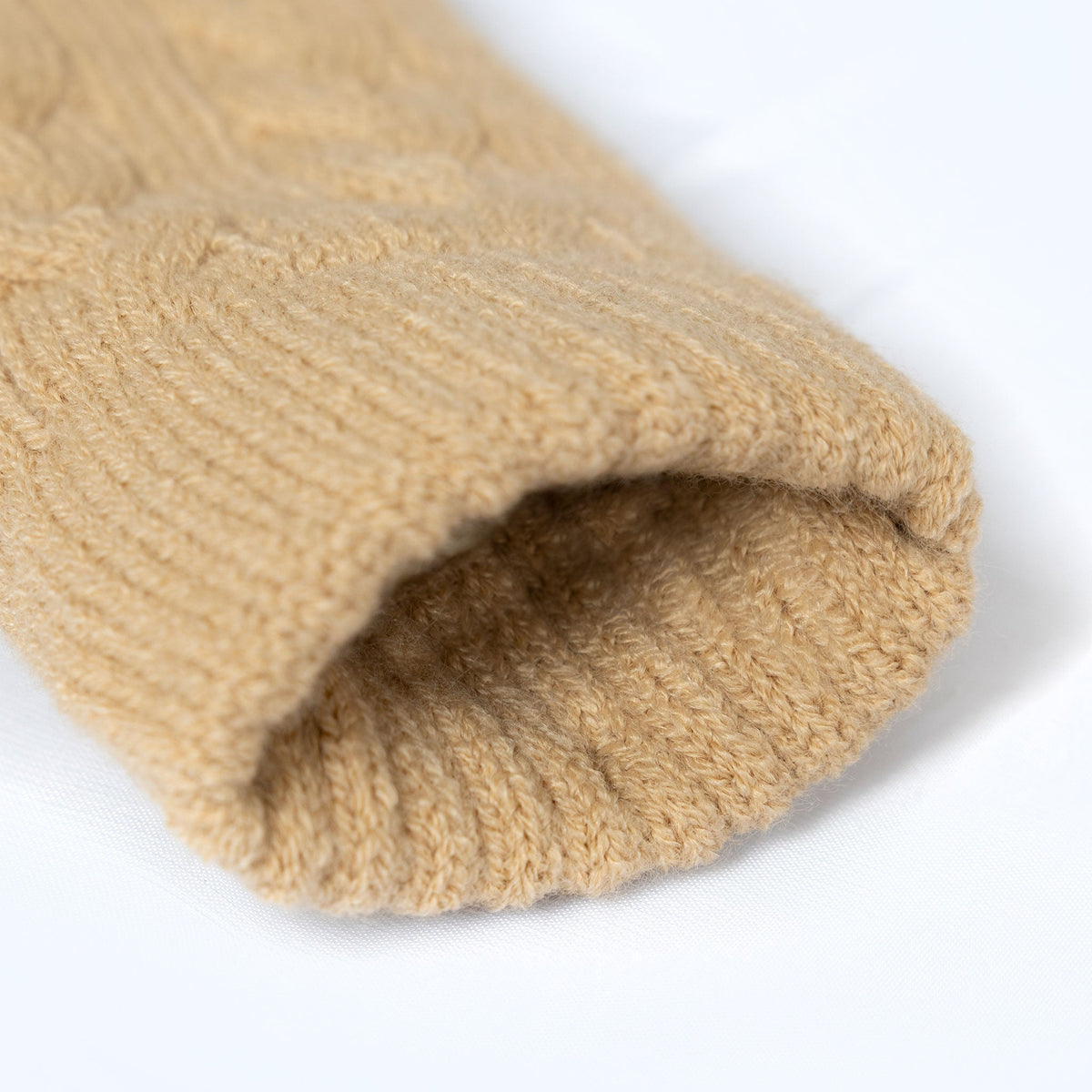 Women's cable knit gloves in beige, open cuff.