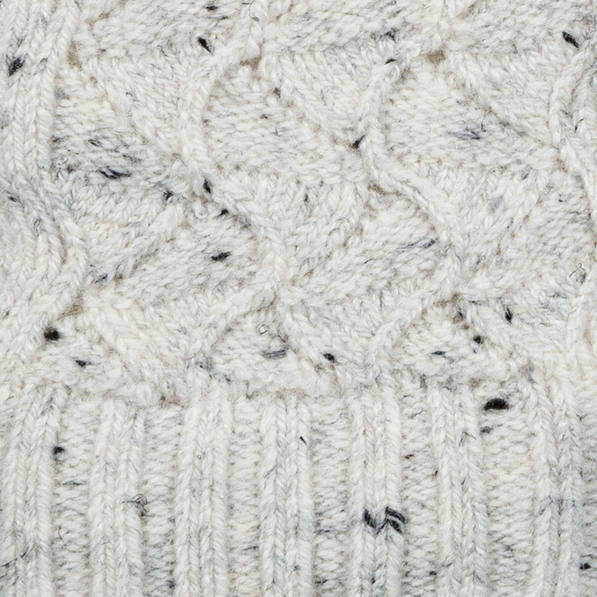 Women's lace knit gloves with marl yarn in white, fabric close up.
