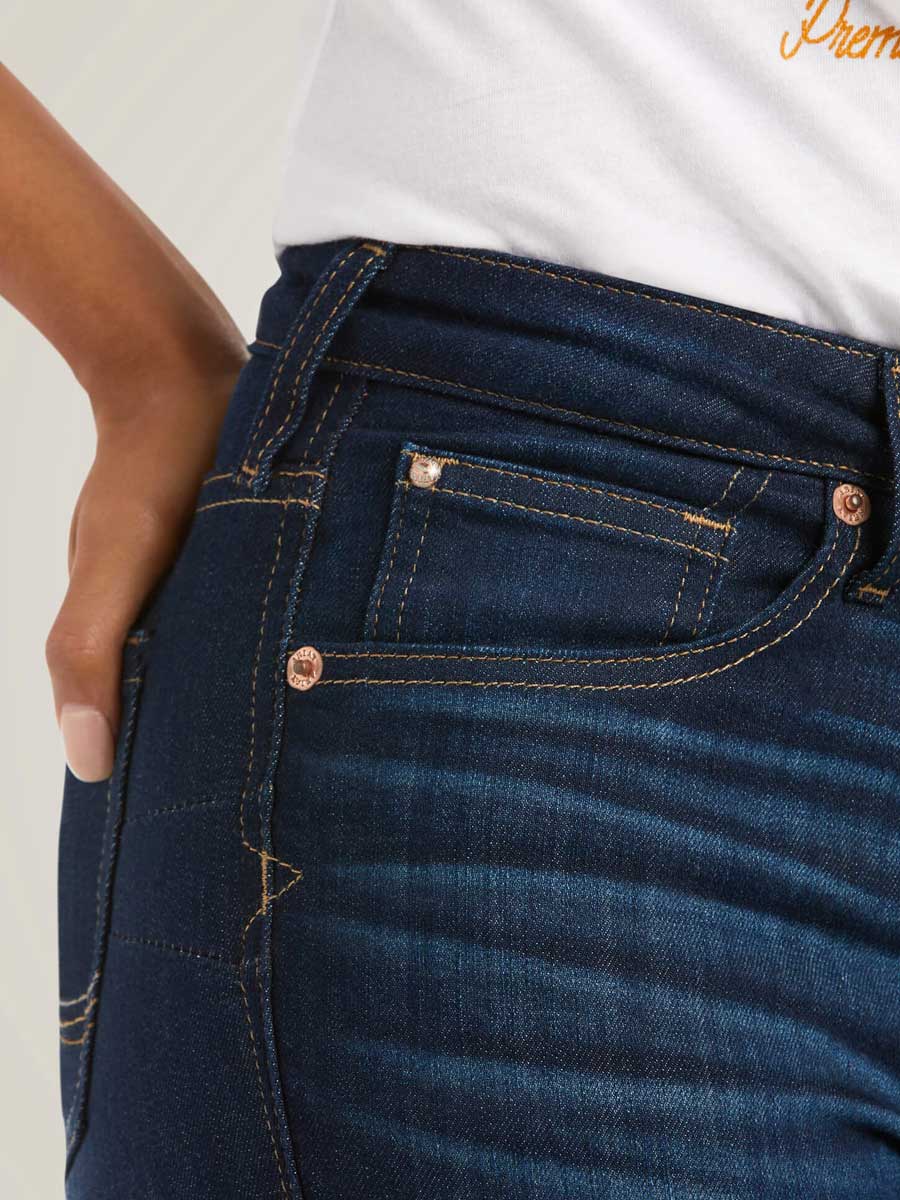Close-up of dark blue jeans with a white background