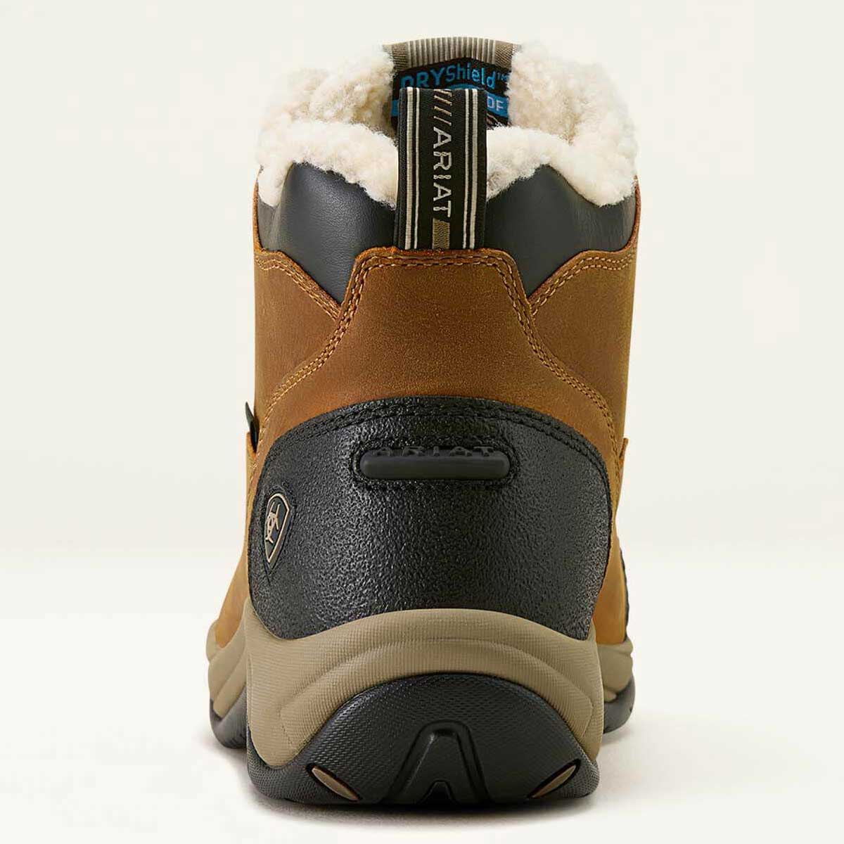 Brown winter boot with black sole and white fur lining on a white background