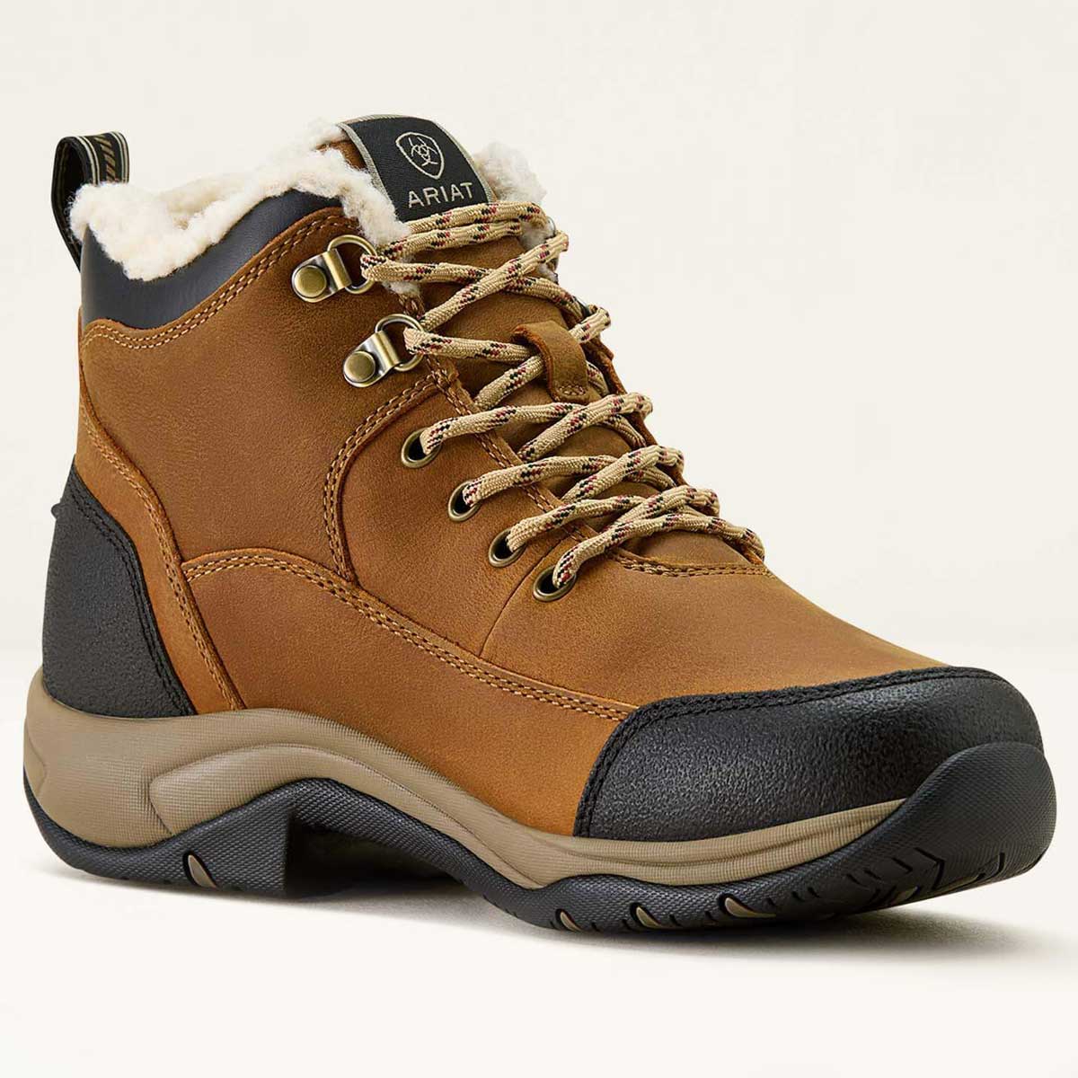 Brown hiking boot with black sole on a white background