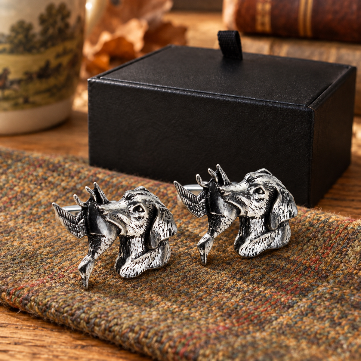 Pewter retriever and duck cufflinks displayed on country tweed in front of Farley's black presentation box
