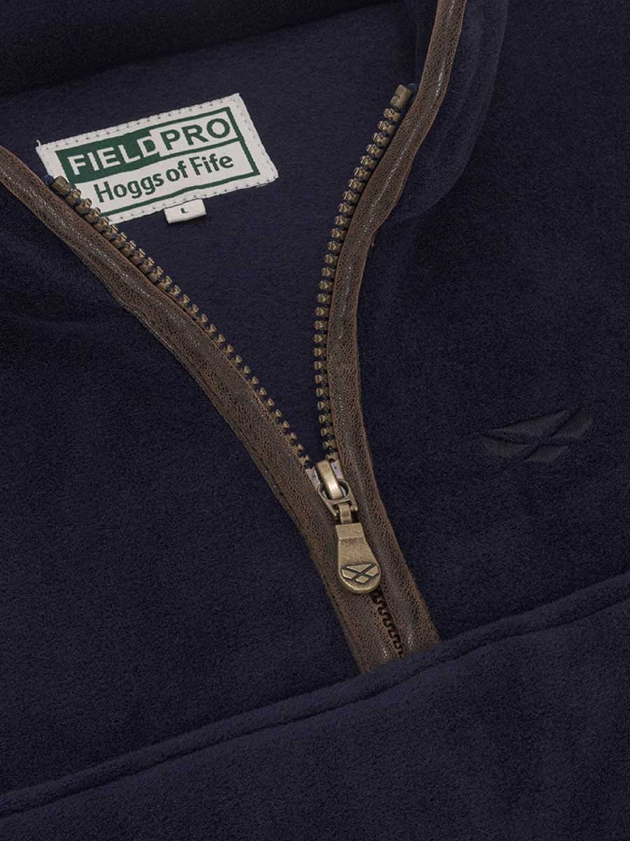Close-up of a navy jacket with a zipper and 'Field Pro Hogg's of Fife' logo.