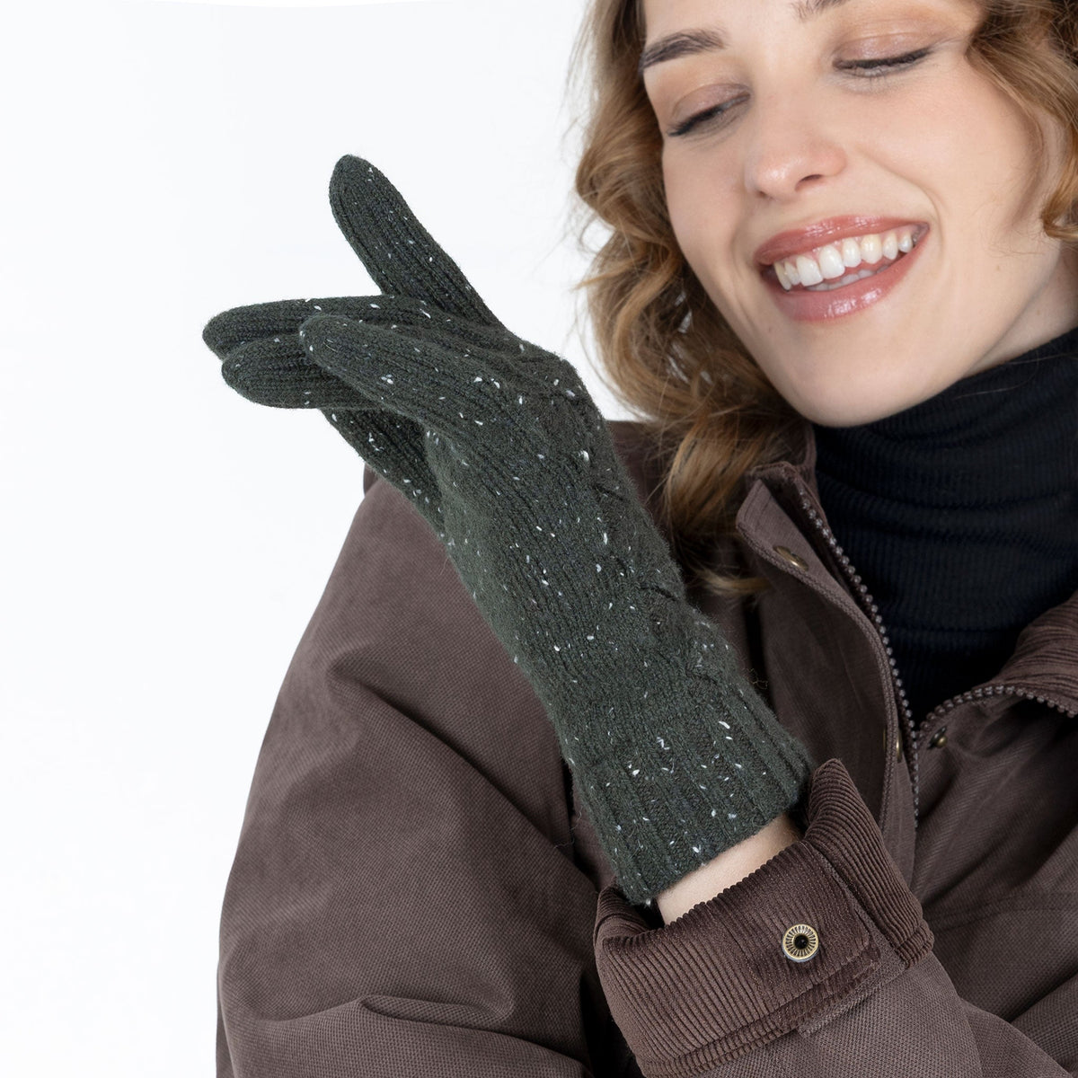 Woman wearing green lace knit gloves with marl yarn