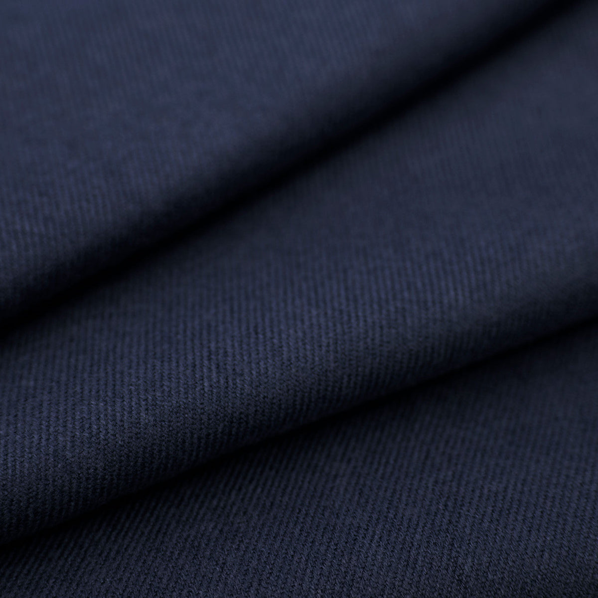 Close up of folded women's pashmina shawl in navy