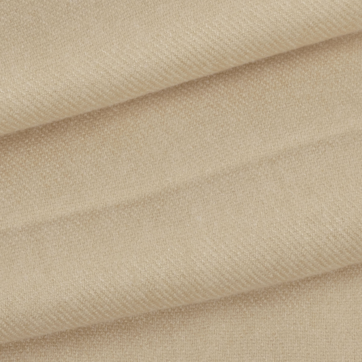 Close up of a folded up women's pashmina shawl in oat