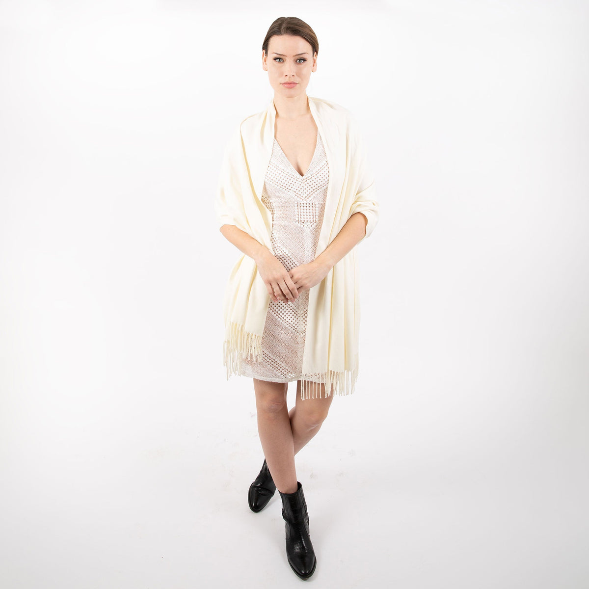 Woman wearing plain pashmina shawl in ivory - draped over her shoulders