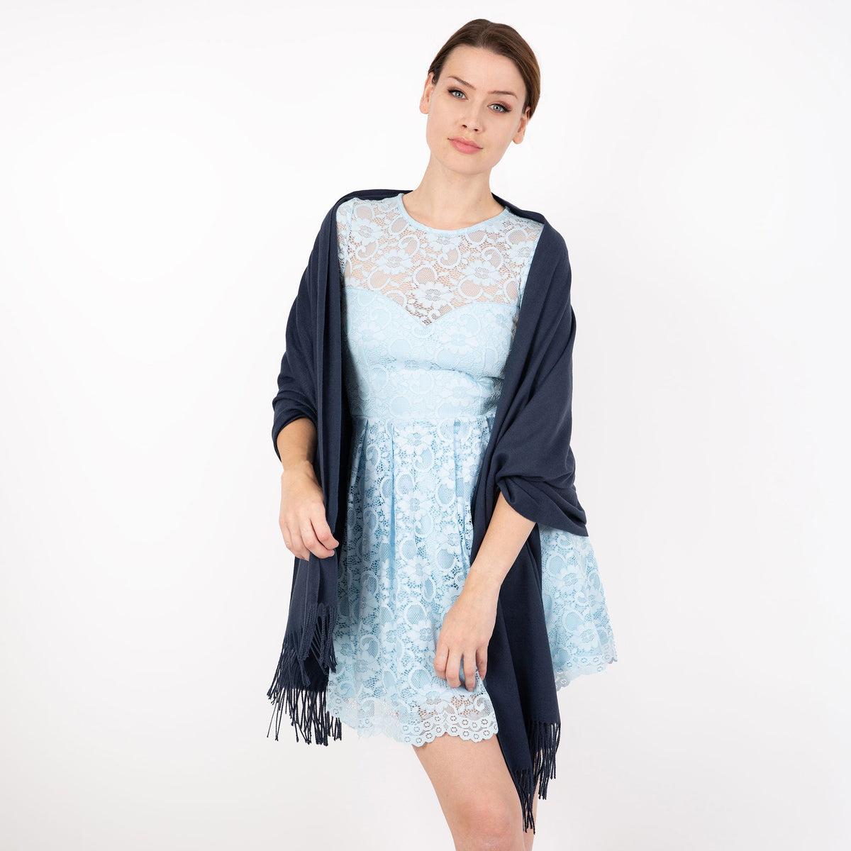 Woman wearing plain pashmina shawl in navy - draped over her shoulders
