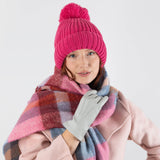 Woman wearing three point leather gloves silver. 