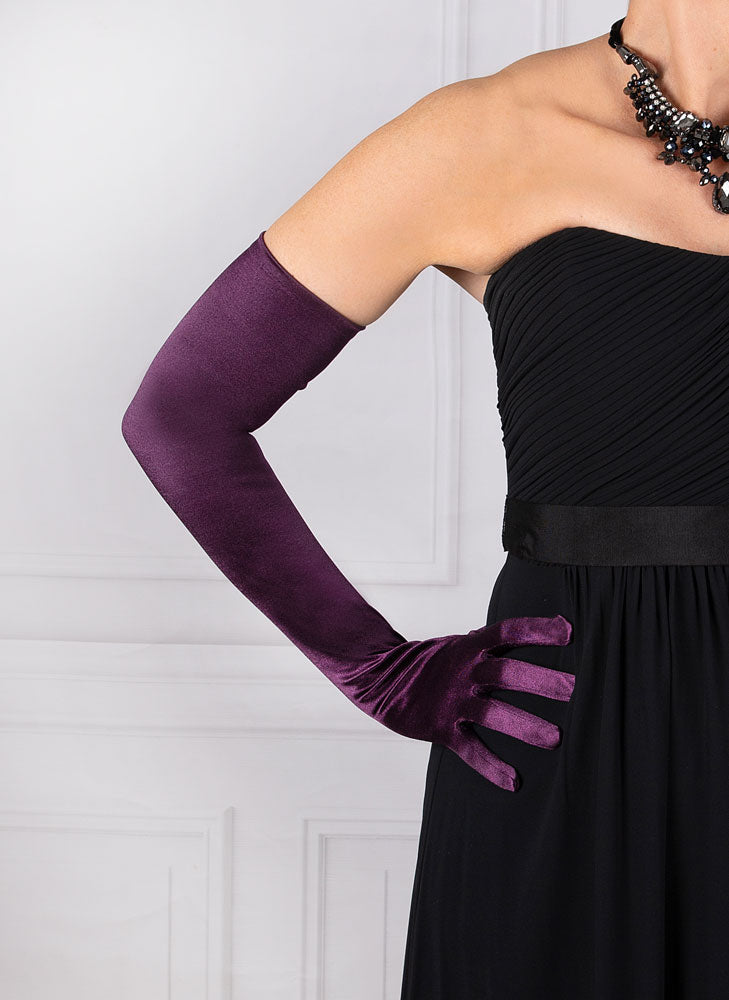 Woman wearing amethyst purple opera satin gloves with an evening dress