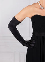 Woman wearing black opera satin gloves with an evening dress