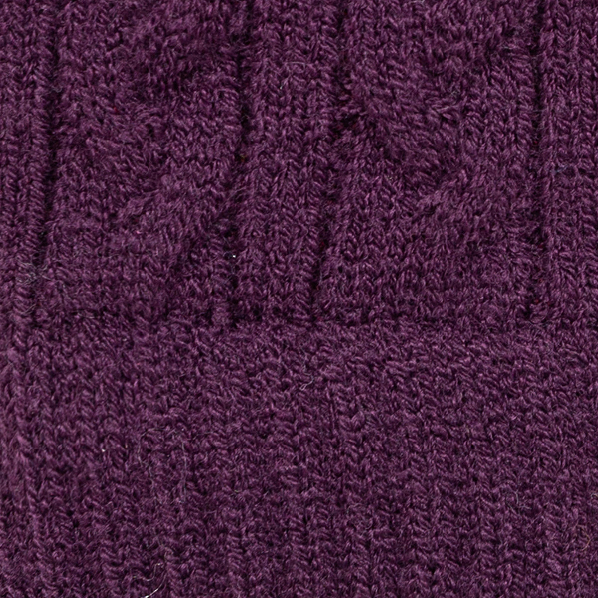 Women's cable knit gloves in purple, fabric close up. 