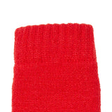 Women's cable knit gloves in red, left hand close up. 