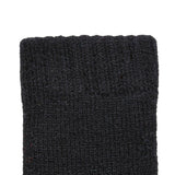 Women's cable knit gloves in black, left hand close up. 