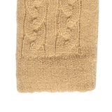 Women's cable knit gloves in beige, right hand close up. 