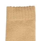 Women's cable knit gloves in beige, left hand close up.