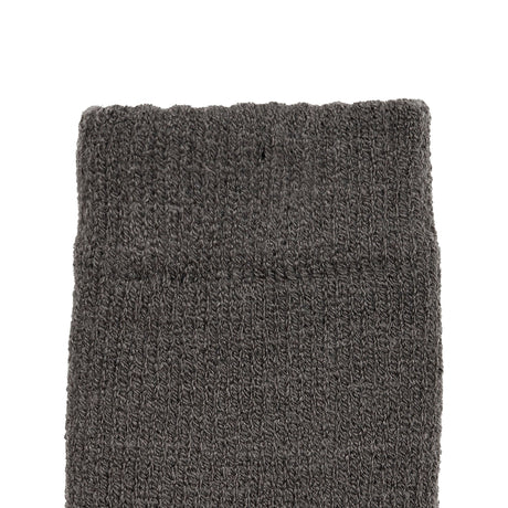 Women's cable knit gloves in dark grey, left hand close up. 