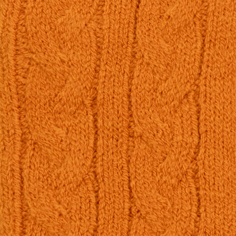 Women's cable knit gloves in orange, fabric close up. 