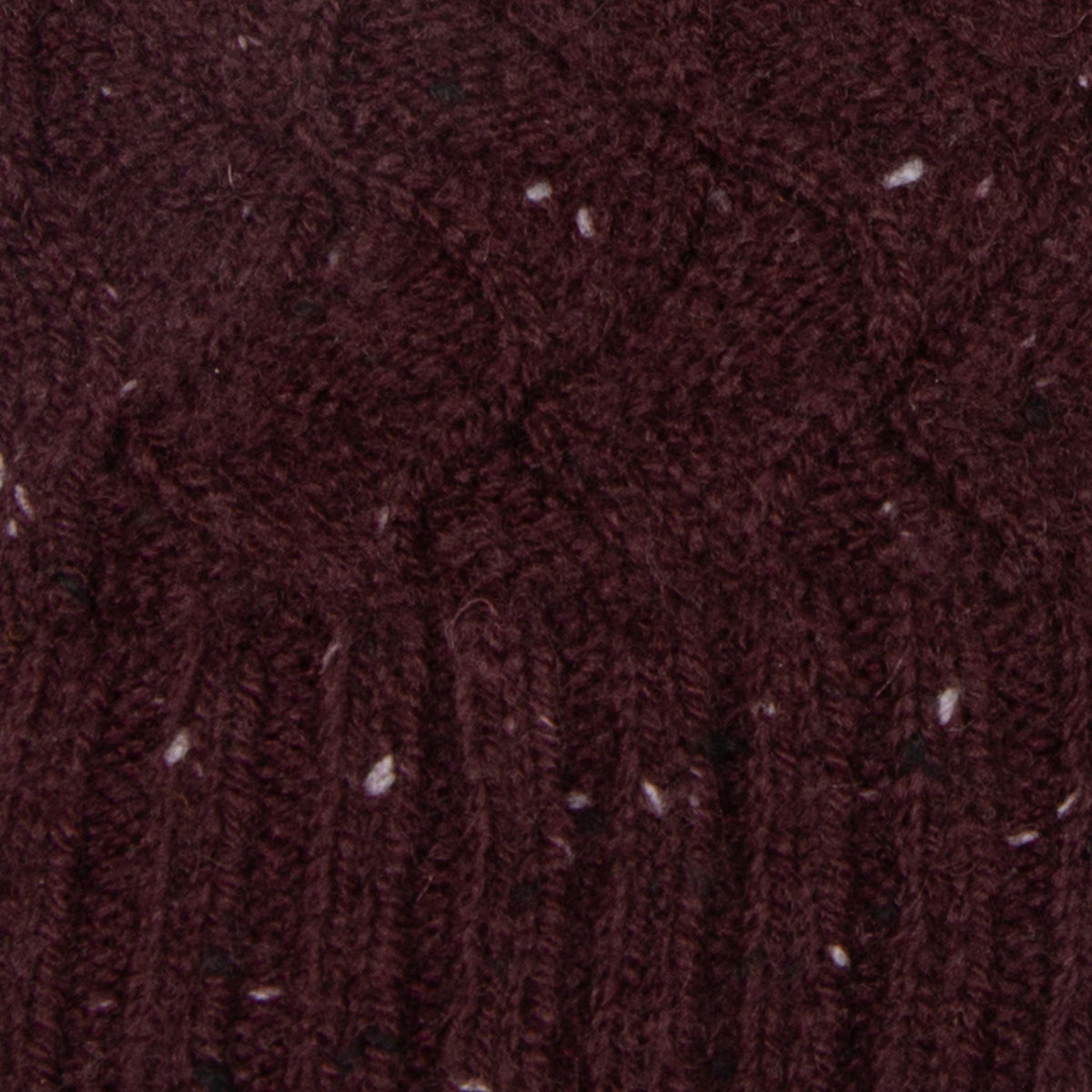 Women's lace knit gloves with marl yarn in burgundy, fabric close up.