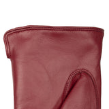 Women's touchscreen single point faux fur lined leather gloves in red, left hand close up. 