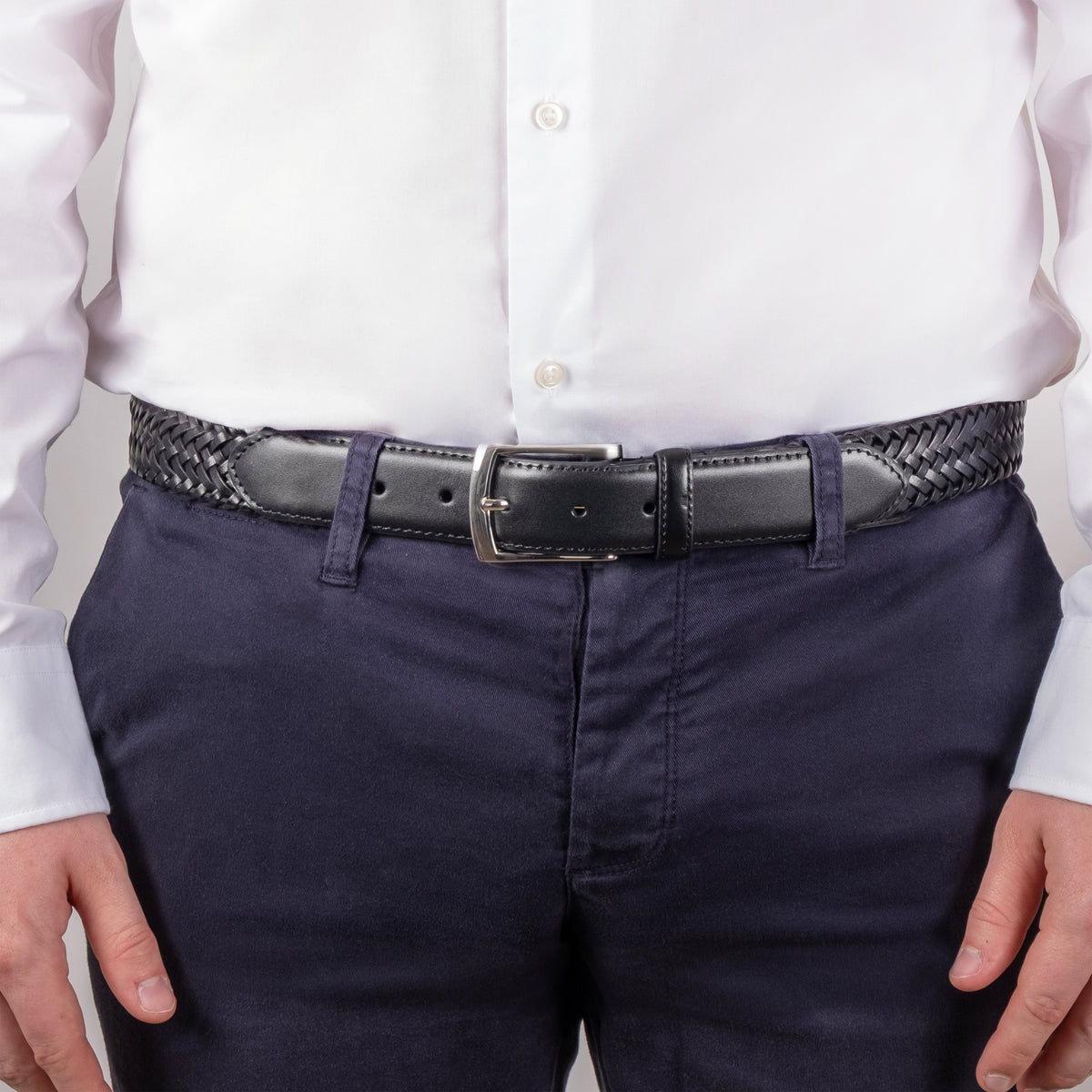 Man wearing woven leather belt with satin nickel buckle in black