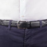 Man wearing woven leather belt with satin nickel buckle in black, buckle close up