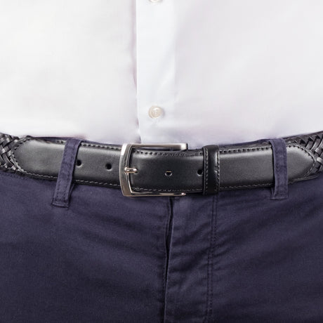 Man wearing woven leather belt with satin nickel buckle in black, buckle close up