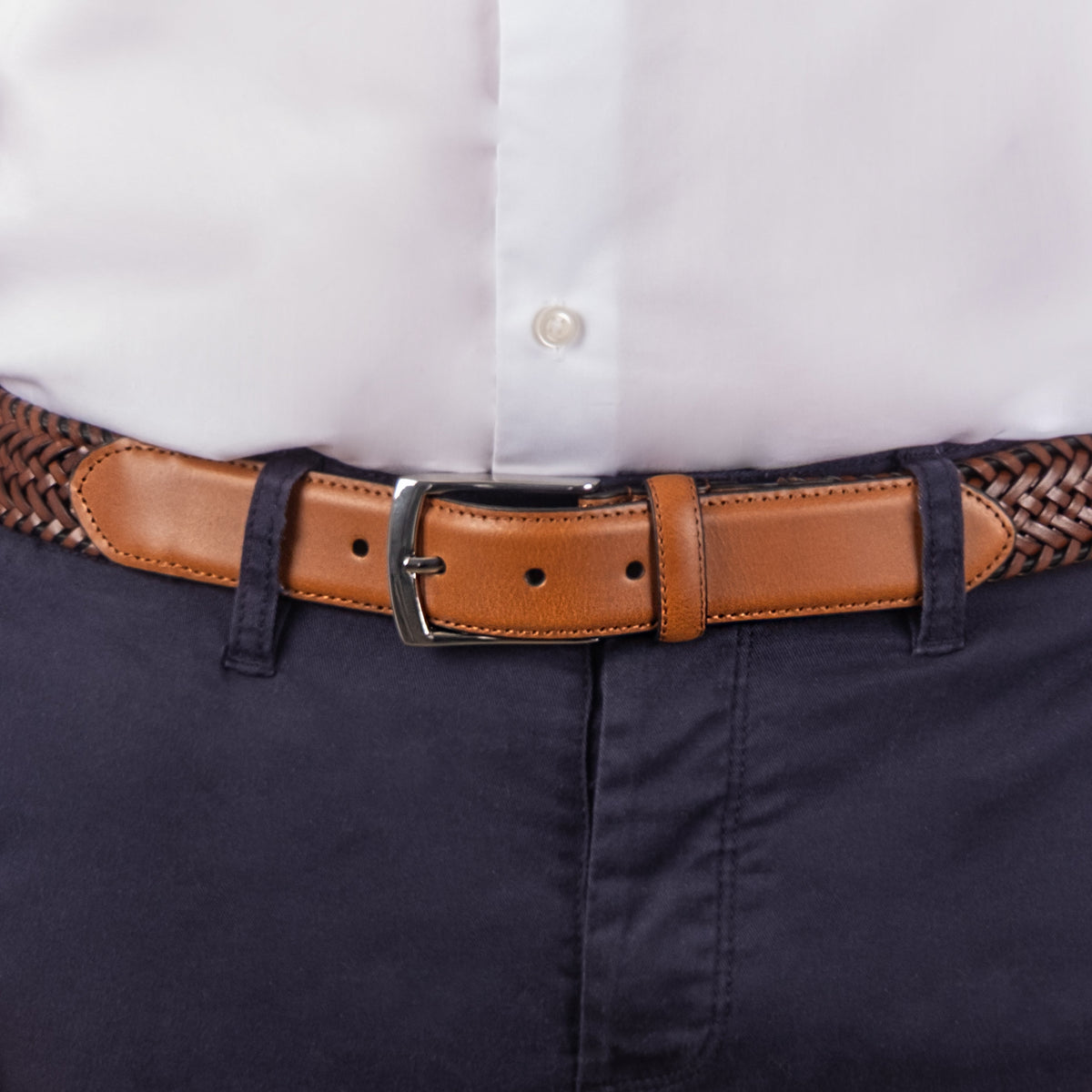 Man wearing woven leather belt with satin nickel buckle in tan, close up
