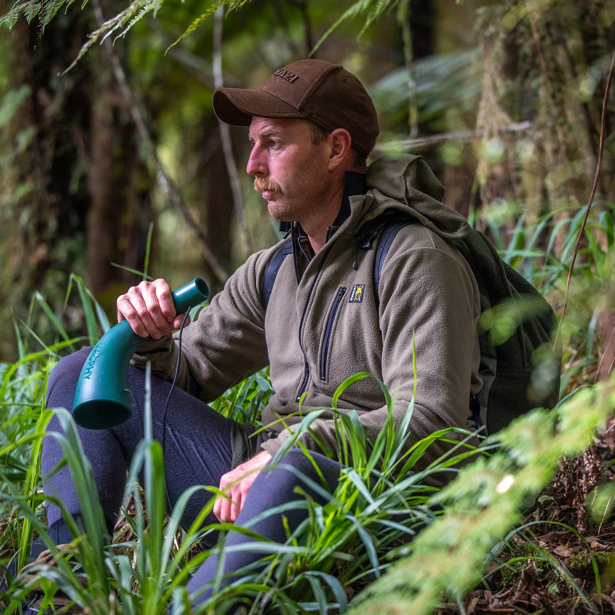 Swazi Brocco Shirt in Tussock, worn while seated in woodland
