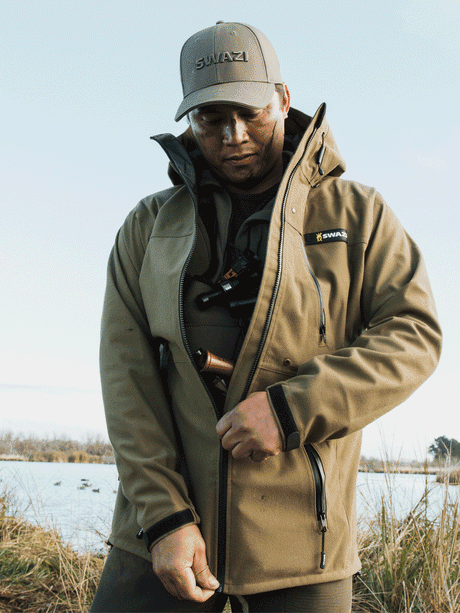 Swazi Ibex Waterproof Hunting Jacket in European Olive, worn outdoors showing the full front of the jacket