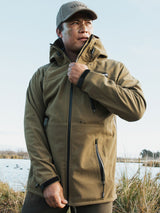 Swazi Ibex Waterproof Hunting Jacket in European Olive, worn outdoors with the collar raised