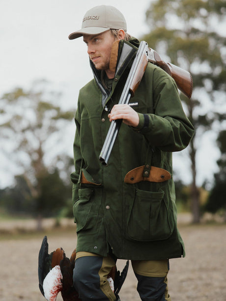 Swazi Wapiti XP Hunting Jacket in Olive, worn outdoors with a dog