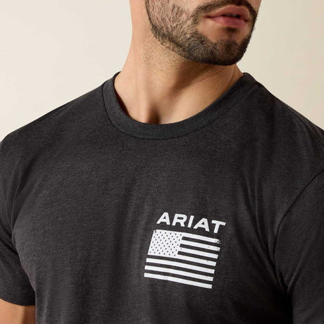 Man wearing a black t-shirt with Ariat logo and American flag design.