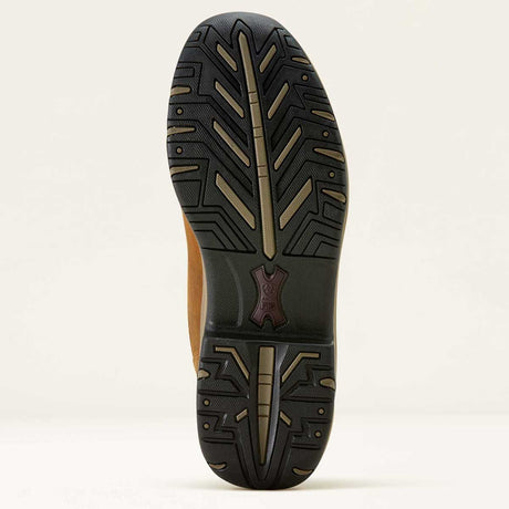 Close-up of a shoe sole with tread pattern on a light beige background