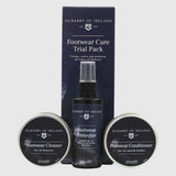 Dubarry of Ireland Footwear Care Trial Pack including a Footwear Protector spray bottle, Footwear Cleaner tin, and Footwear Conditioner tin, displayed in front of its dark navy blue retail box on a light gray background.
