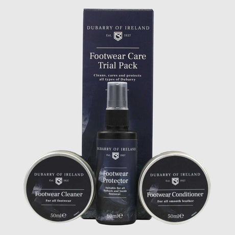 Dubarry of Ireland Footwear Care Trial Pack including a Footwear Protector spray bottle, Footwear Cleaner tin, and Footwear Conditioner tin, displayed in front of its dark navy blue retail box on a light gray background.