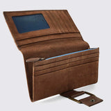 An open brown leather bi-fold wallet with card slots, a blue ID window, a zippered compartment, and a detachable metal buckle strap, shown on a light gray background.