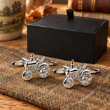Pair of silver-tone tractor cufflinks displayed on tweed beside Farley's black presentation box