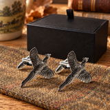 Farley's flying pheasant English pewter cufflinks on tweed beside the black presentation box