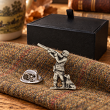 Farley's hunter and dog English pewter lapel pin badge on tweed beside the black presentation box