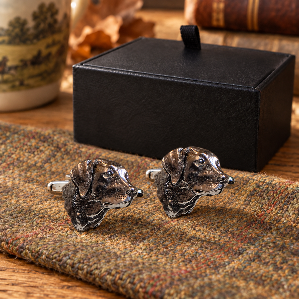 Pewter Labrador head cufflinks displayed on country tweed in front of Farley's black presentation box