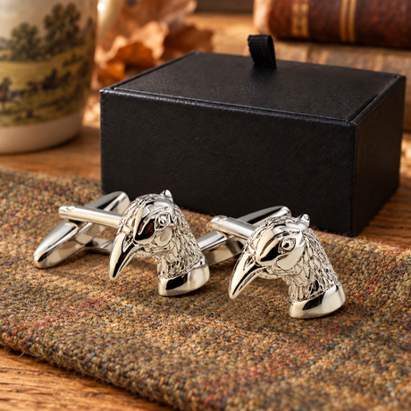 Farley's silver rhodium-plated pheasant head cufflinks on tweed beside the black presentation box