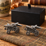 Vintage tractor cufflinks displayed on country tweed beside Farley's black presentation box