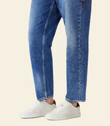 RM Williams Men's Sandbar Leather Trainers - White, rear view worn with jeans