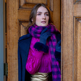 Woman wearing Women's touchscreen velour-lined faux suede gloves with faux fur cuffs in navy by a grand door