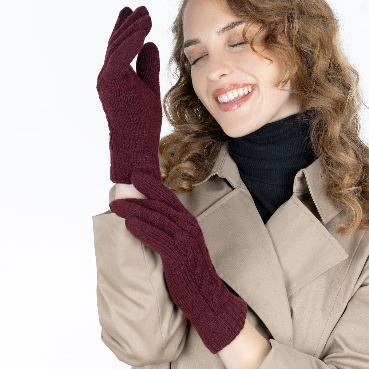 Woman wearing cable knit gloves in damson