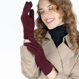 Woman wearing cable knit gloves in damson
