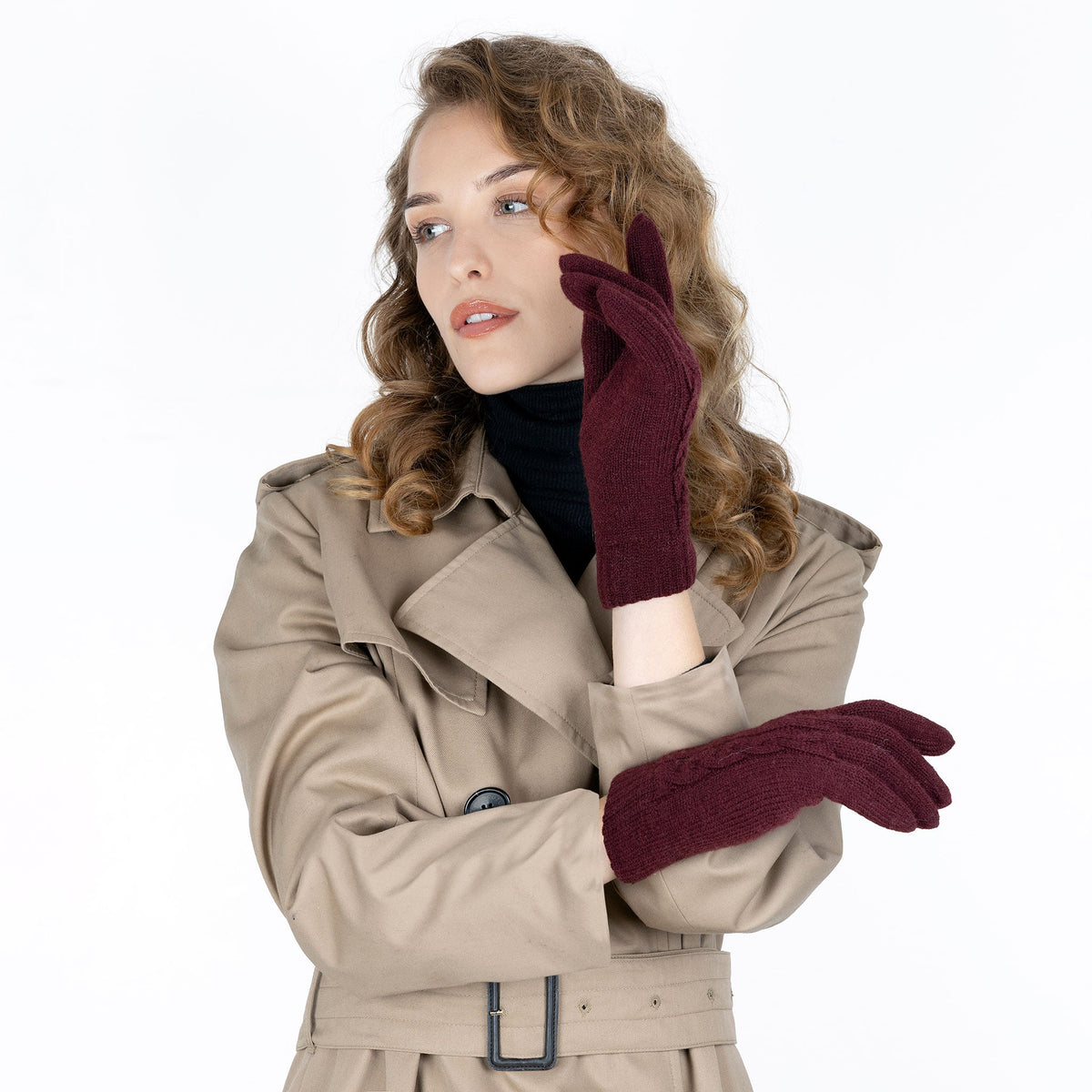 Woman wearing cable knit gloves in damson